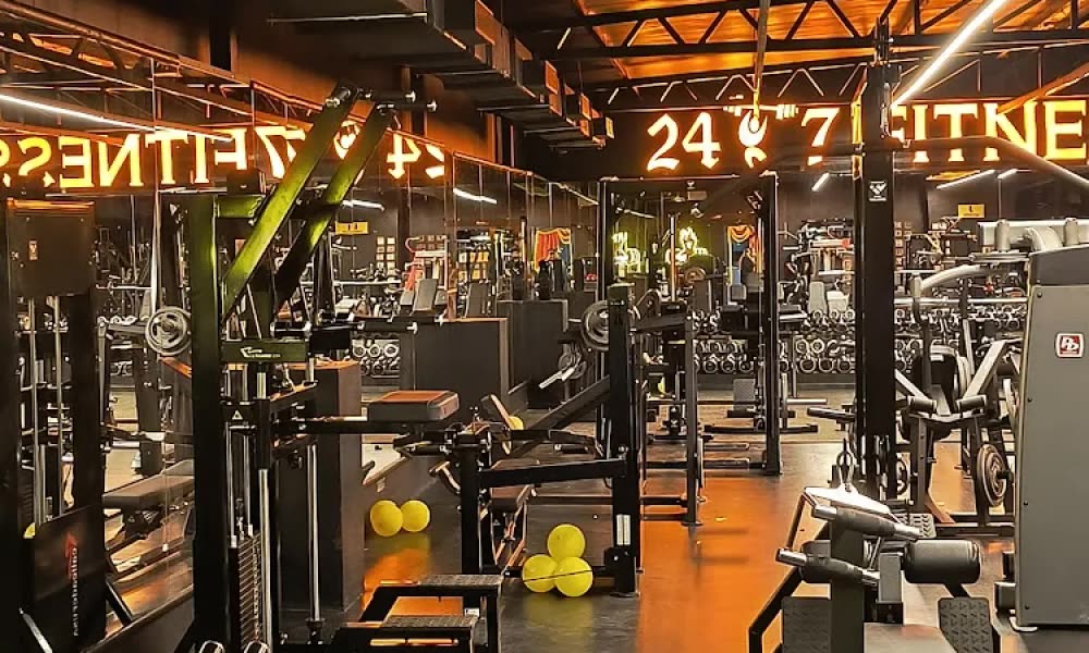 Wide crop of the gym floor with machines and mirrors