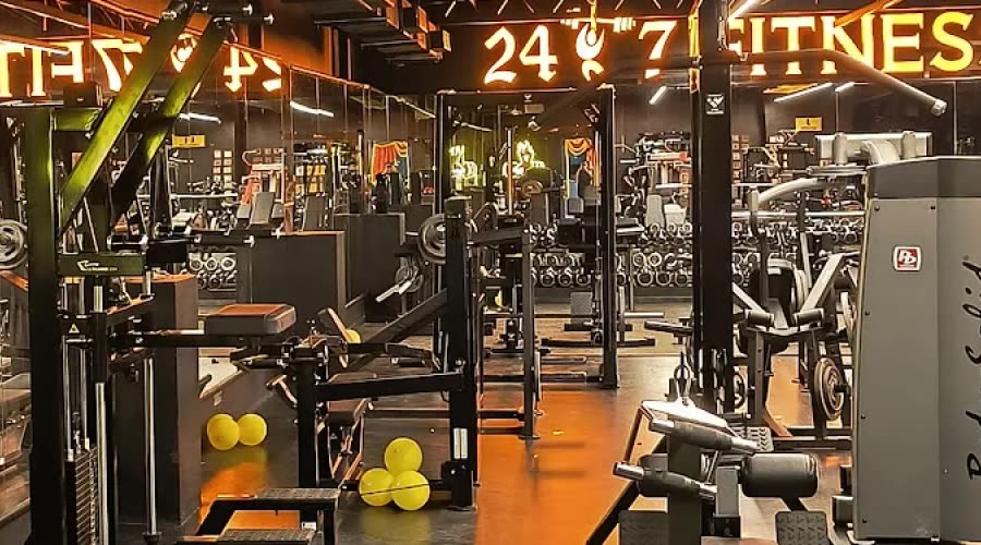 Interior crop showing the illuminated 24 7 Fitness Studio sign